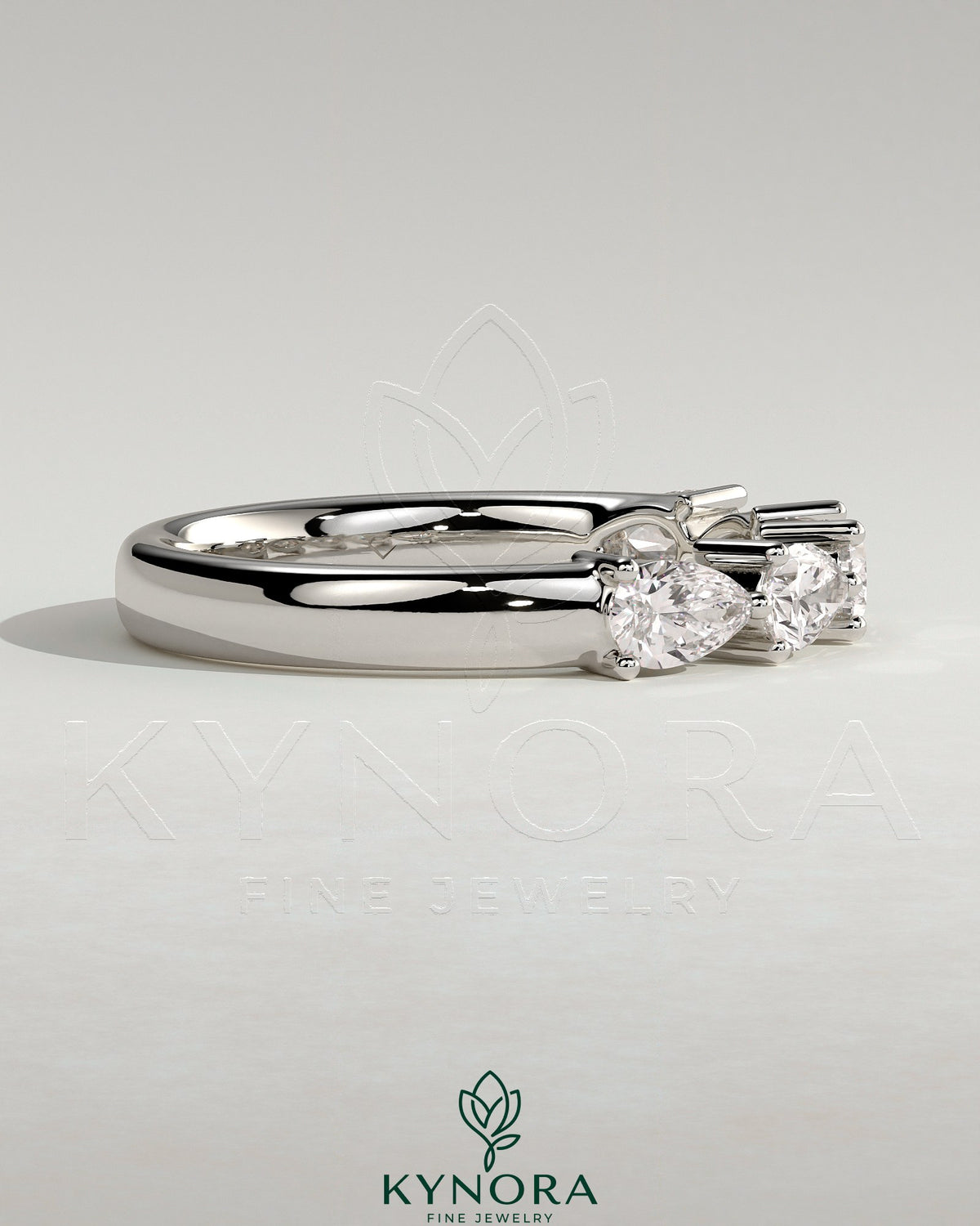 Kynora CJ Pear East West Accent Stone wedding band with closed basket setting, elegant gold wedding ring for women.
