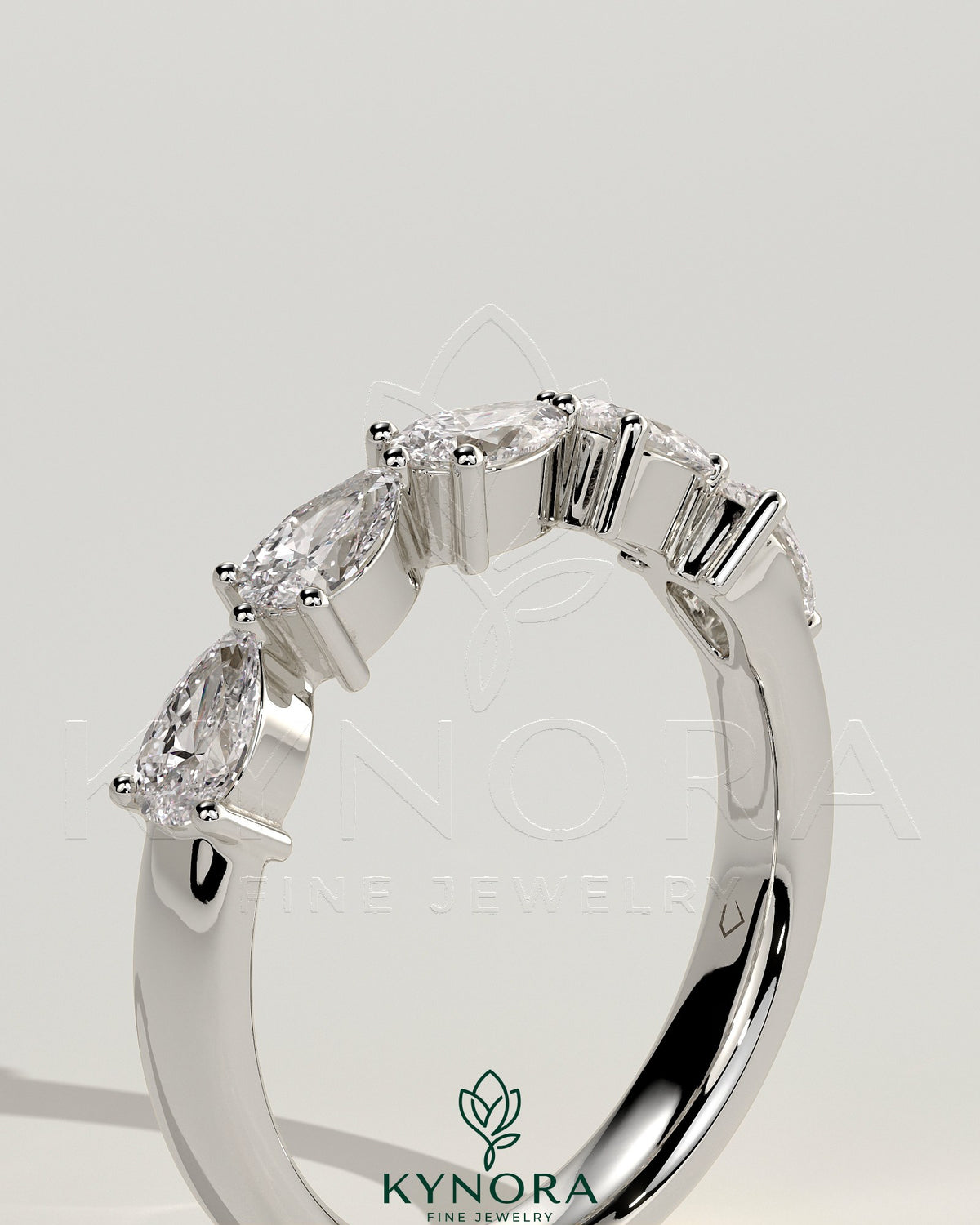Kynora CJ Pear East West accent stone wedding band with closed basket setting, elegant gold wedding ring for special occasions