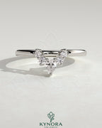 Kynora CJ Pear round accent stone wedding band with curved design, elegant gold wedding ring featuring sparkling gemstones.
