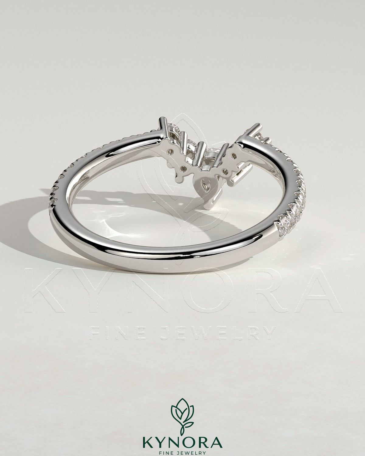 Kynora CJ Pear round accent stone wedding band with curved pave band, elegant gold wedding ring with sparkling gemstones.