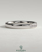 Kynora CJ Princess Princess Channel Set Wedding Ring in a wedding band style with sparkling gemstone accents.