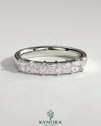 Kynora CJ Radiant East West Accent Stone wedding band with closed basket setting, showcasing sparkling gemstones and sleek gold design.
