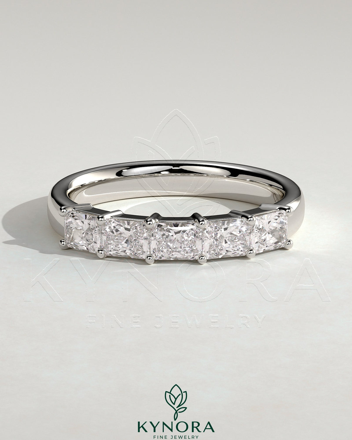 Kynora CJ Radiant East West Accent Stone wedding band with closed basket setting, showcasing sparkling gemstones and sleek gold design.