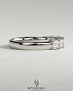 Kynora CJ radiant east-west accent wedding band with closed basket setting, featuring sparkling stones in a sleek gold design.