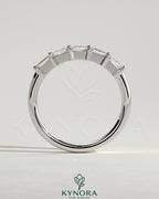 Kynora CJ Radiant East West Accent Stone wedding band with closed basket setting, showcasing sparkling gemstones and elegant design.