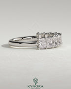 Elegant Kynora CJ Radiant Eternity Band wedding ring with sparkling stones, showcasing its intricate design and polished finish.