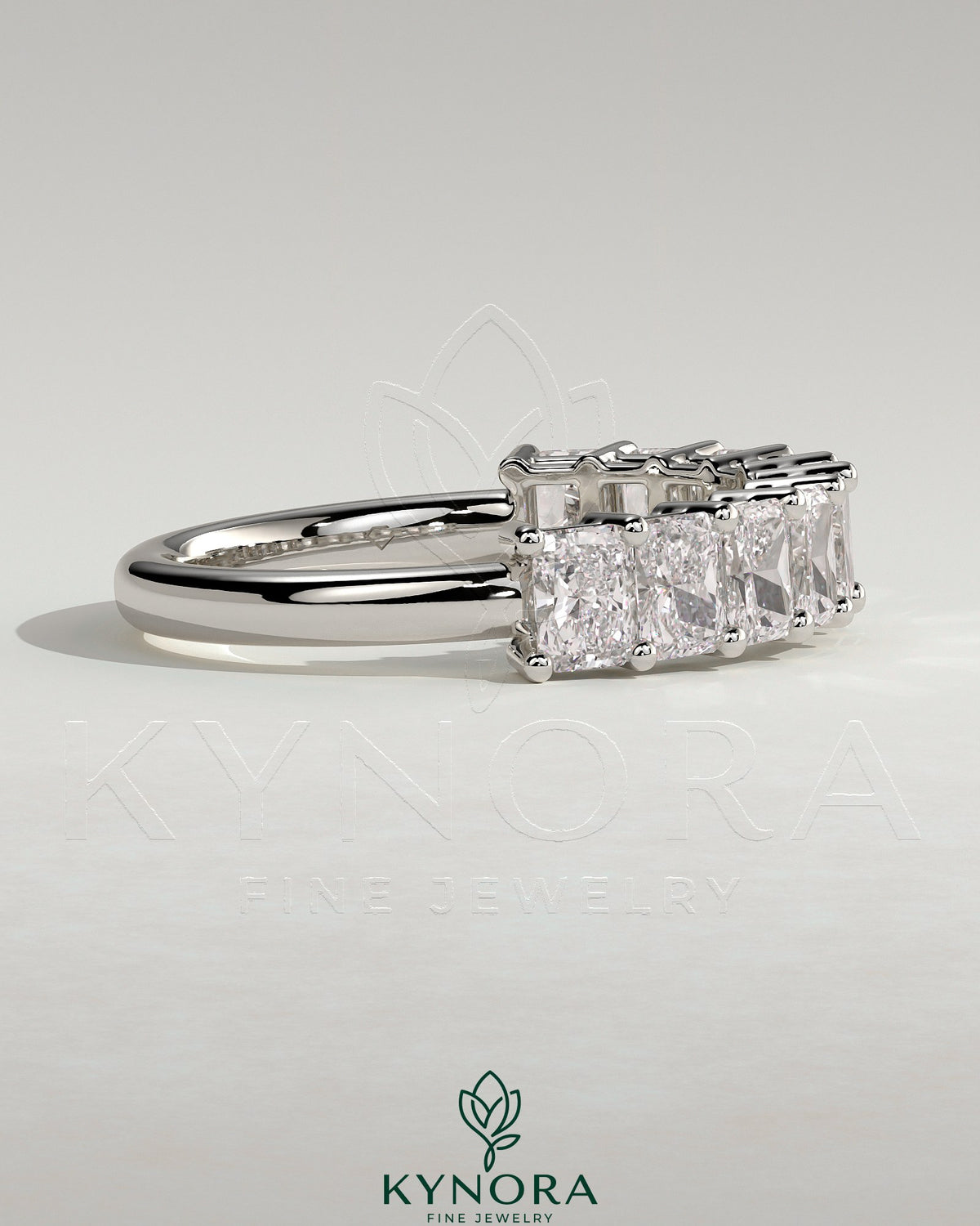Elegant Kynora CJ Radiant Eternity Band wedding ring with sparkling stones, showcasing its intricate design and polished finish.