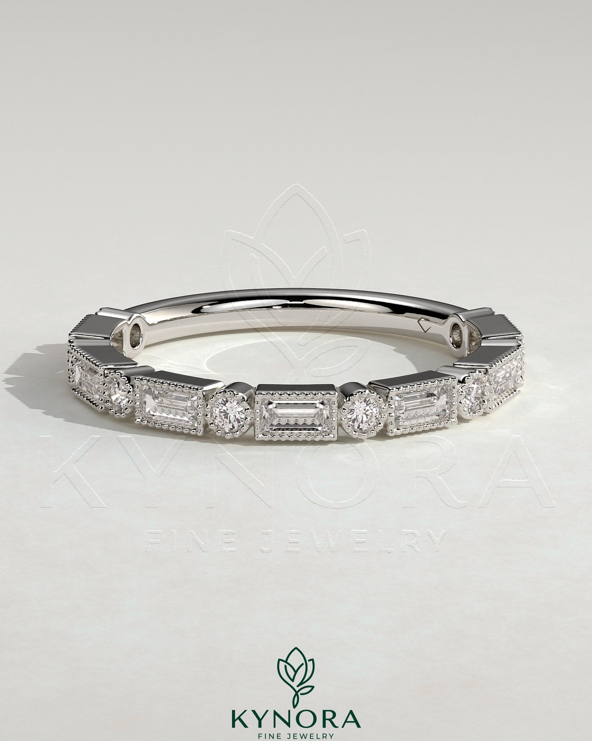 Kynora CJ round wedding band with baguette accent stones and milgrain detailing, showcasing elegant, handcrafted jewelry design. Imagen principal del producto