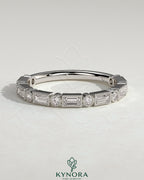 Kynora CJ round wedding band with baguette accent stones and milgrain detailing, showcasing elegant, handcrafted jewelry design.