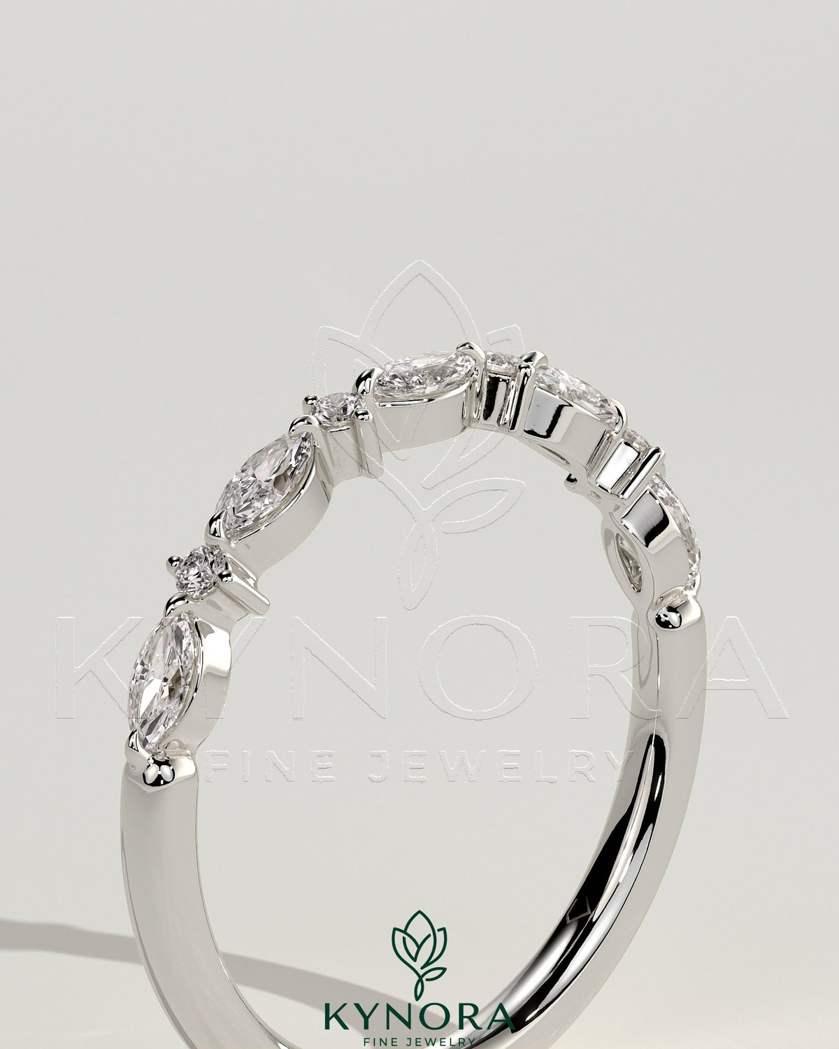 Round marquise accent stones wedding band by Kynora CJ, showcasing a sleek gold wedding ring with marquise-shaped gemstones.