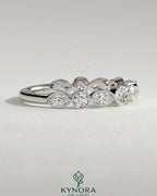Kynora CJ round marquise bezel set wedding ring with sparkling marquise-shaped gemstones on a sleek band.