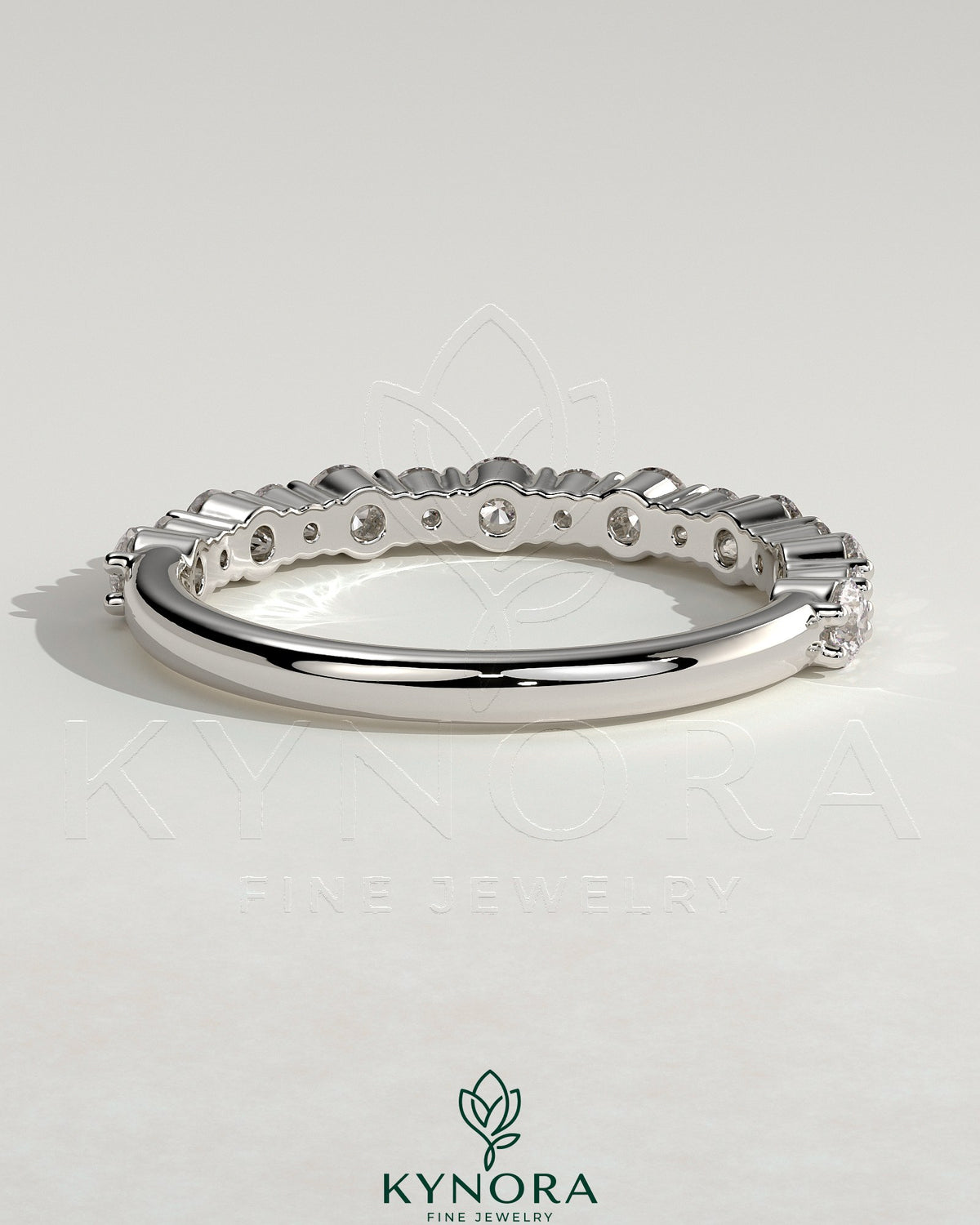 Round mixed size accent stone wedding band by Kynora CJ featuring a sleek, elegant design with alternating stones on a polished band.