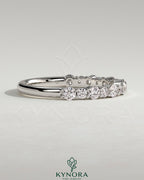 Kynora CJ round mixed size accent stone wedding band with variously sized stones, crafted for elegant wedding jewelry.