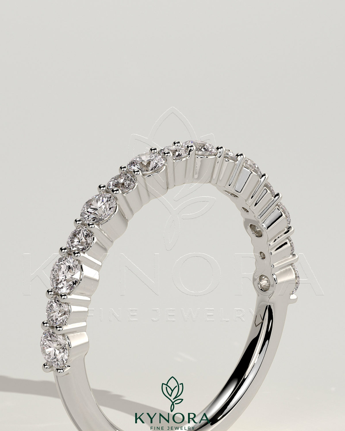 Kynora CJ round mixed size accent stone wedding band with various sized sparkling stones on silver-tone metal.