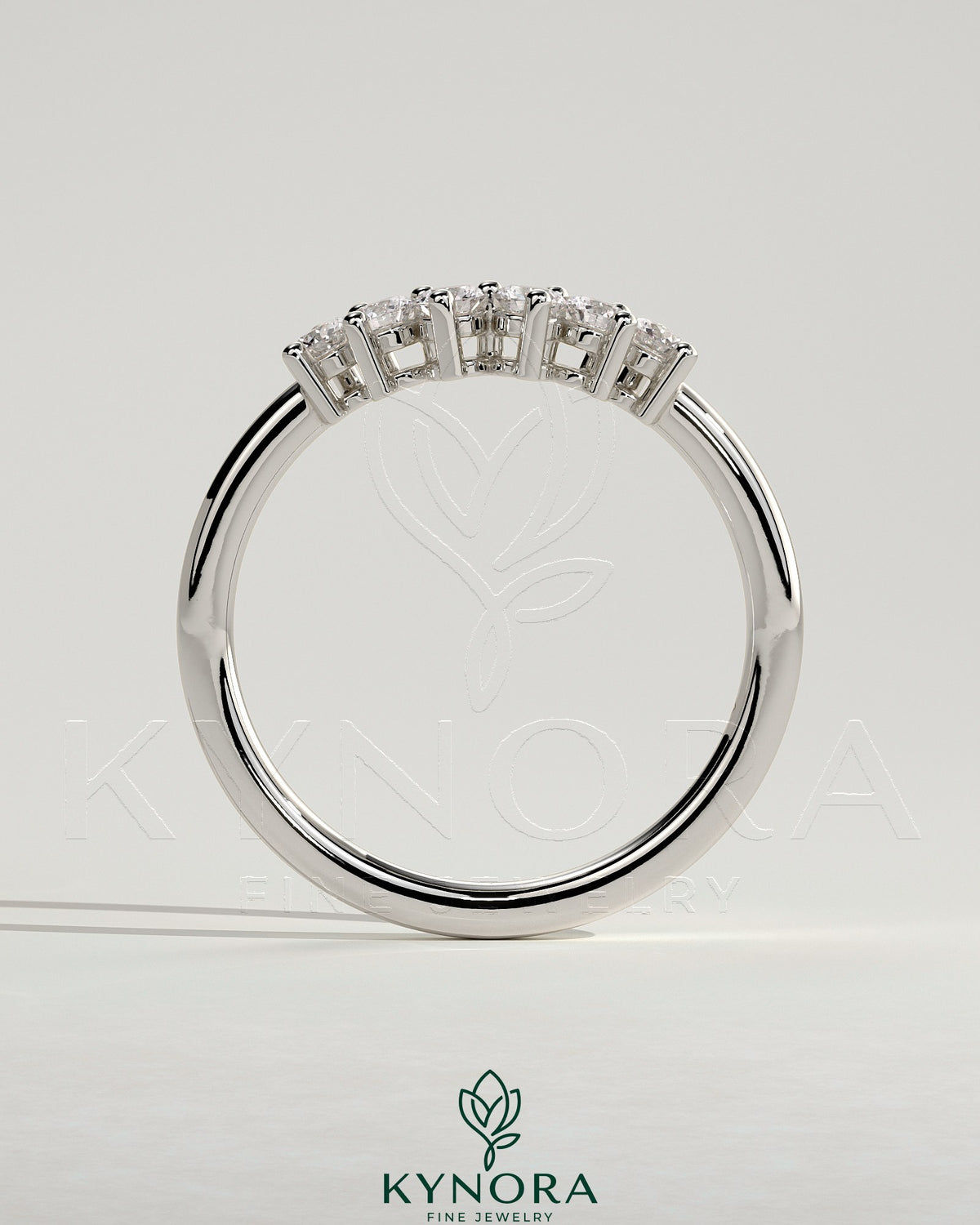 Kynora CJ round accent stone wedding band with curved design, showcasing polished gold finish and sparkling gemstone details.