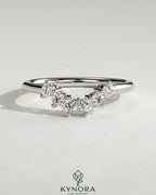Kynora CJ round accent wedding band with curved design and sparkling stones on polished gold band for elegant bridal jewelry