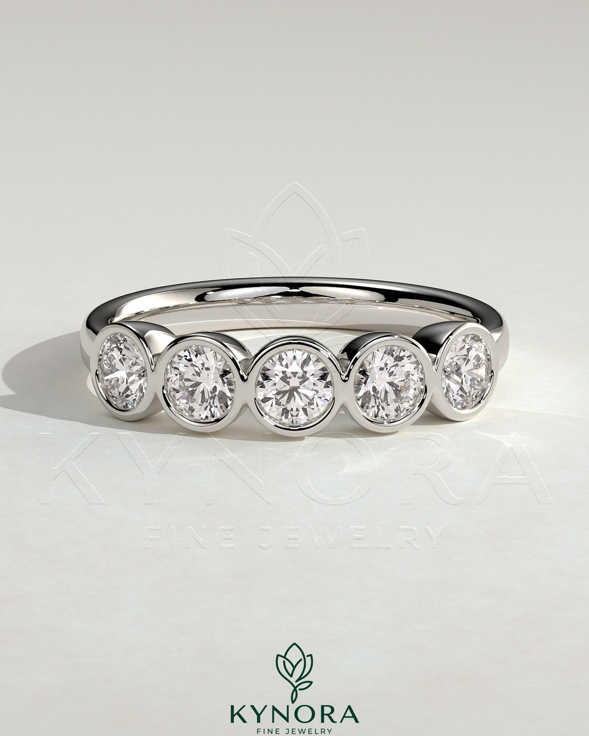 Kynora CJ round bezel set wedding band with a sleek, polished design, showcasing a smooth, circular bezel setting on the gold ring.