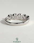 Kynora CJ round bezel set wedding band with a sleek, polished finish, designed for elegant bridal jewelry.