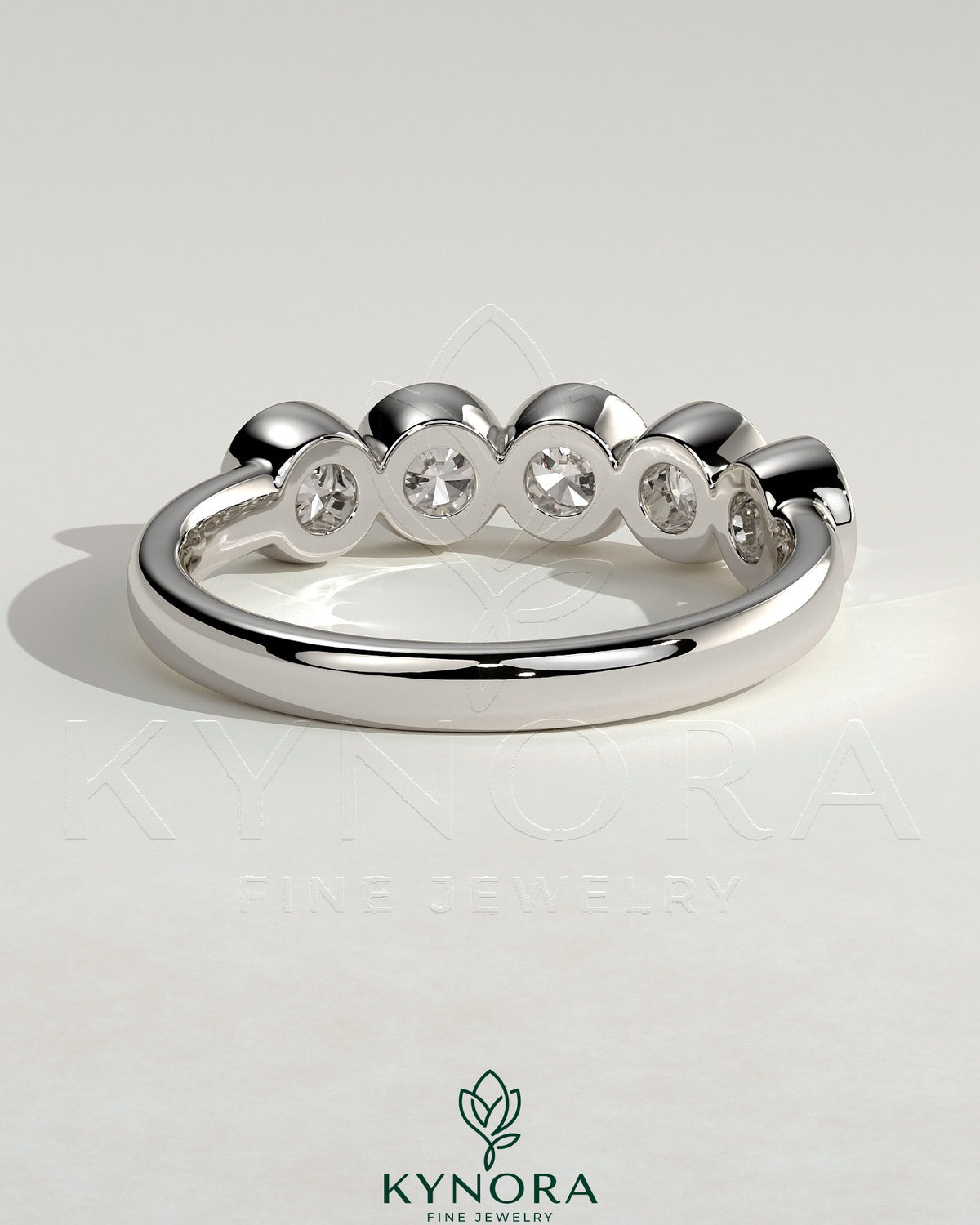 Kynora CJ round bezel set wedding band with a sleek, polished finish, designed for elegant bridal jewelry.