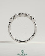 Round bezel set wedding ring by Kynora CJ, elegant wedding band with a smooth, polished finish and a central gemstone setting.