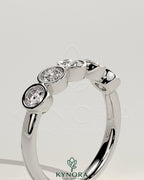 Round bezel set wedding ring by Kynora CJ, featuring a sleek design and polished finish, perfect for wedding band jewelry.