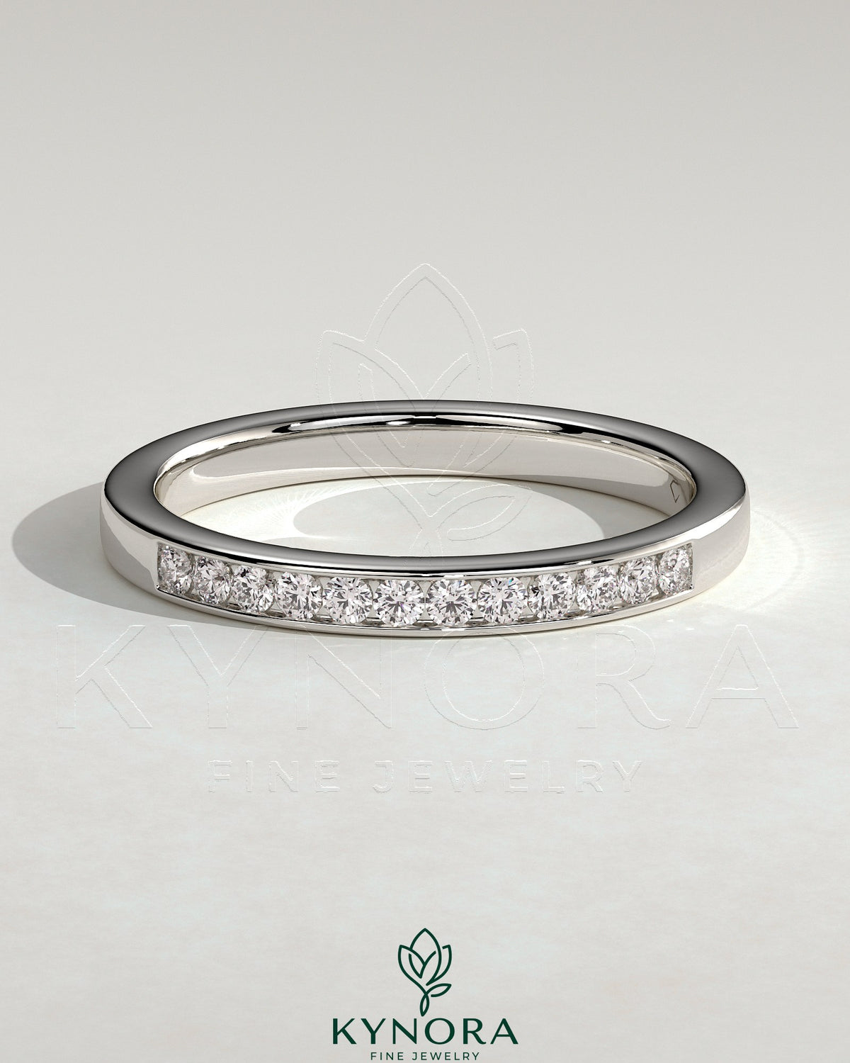 Kynora CJ round channel set wedding band with a sleek, polished design featuring embedded gemstones on a silver band. Main image