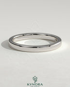 Kynora CJ round channel set wedding band with a sleek, polished gold finish, featuring a continuous row of sparkling gemstones.