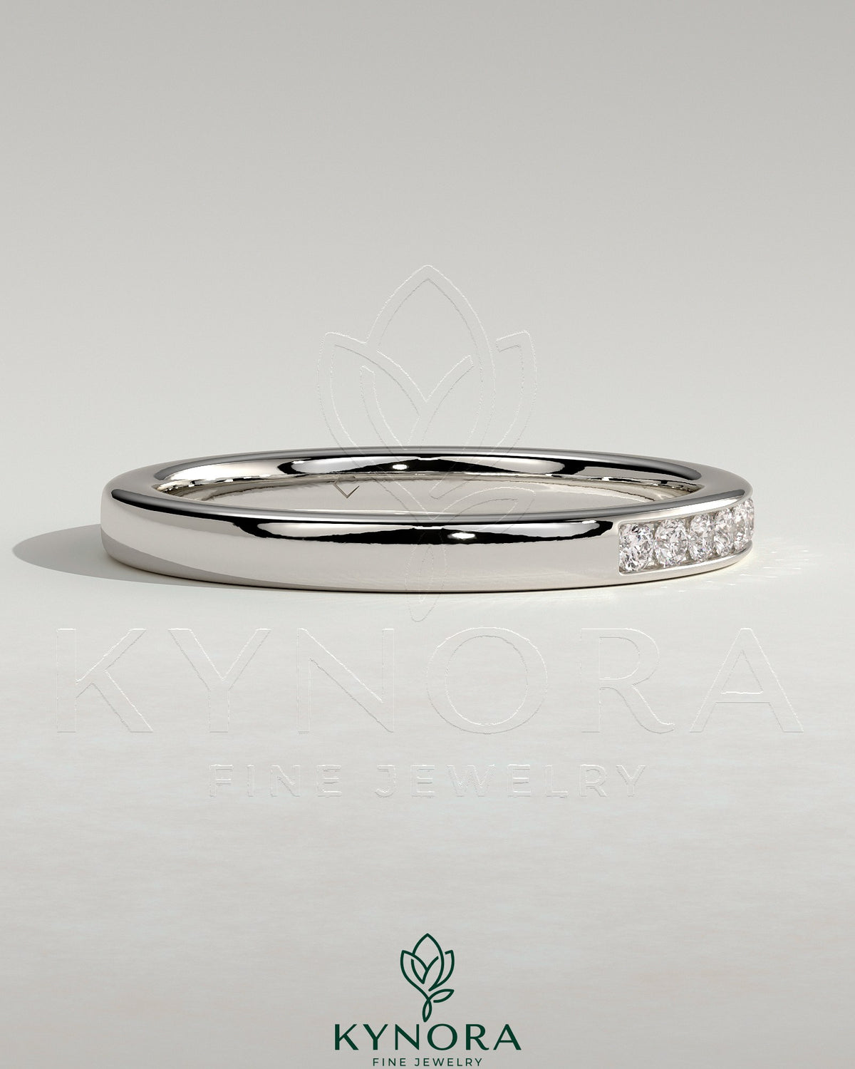 Kynora CJ round channel set wedding band with a sleek, polished finish, featuring a continuous row of gemstones on a silver-tone band.