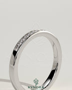 Kynora CJ round channel set wedding band with smooth polished finish, designed for elegant bridal jewelry.