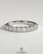 Kynora CJ round eternity wedding band in polished metal with continuous gemstone setting, elegant and timeless jewelry piece