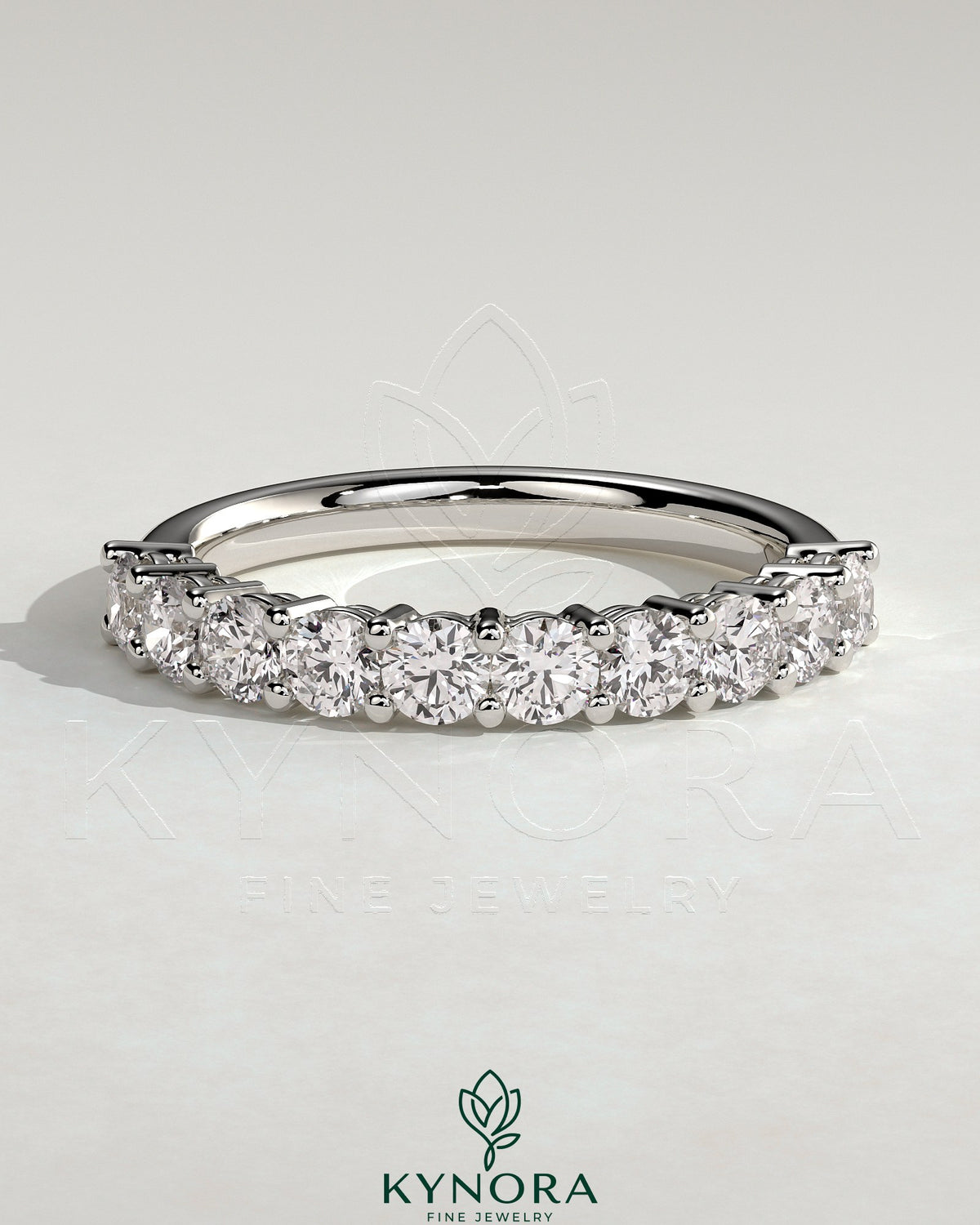 Kynora CJ round eternity wedding band in polished metal with continuous gemstone setting, elegant and timeless jewelry piece