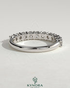 Kynora CJ round eternity wedding band ring with continuous diamond or gemstone design, elegant and timeless jewelry piece.