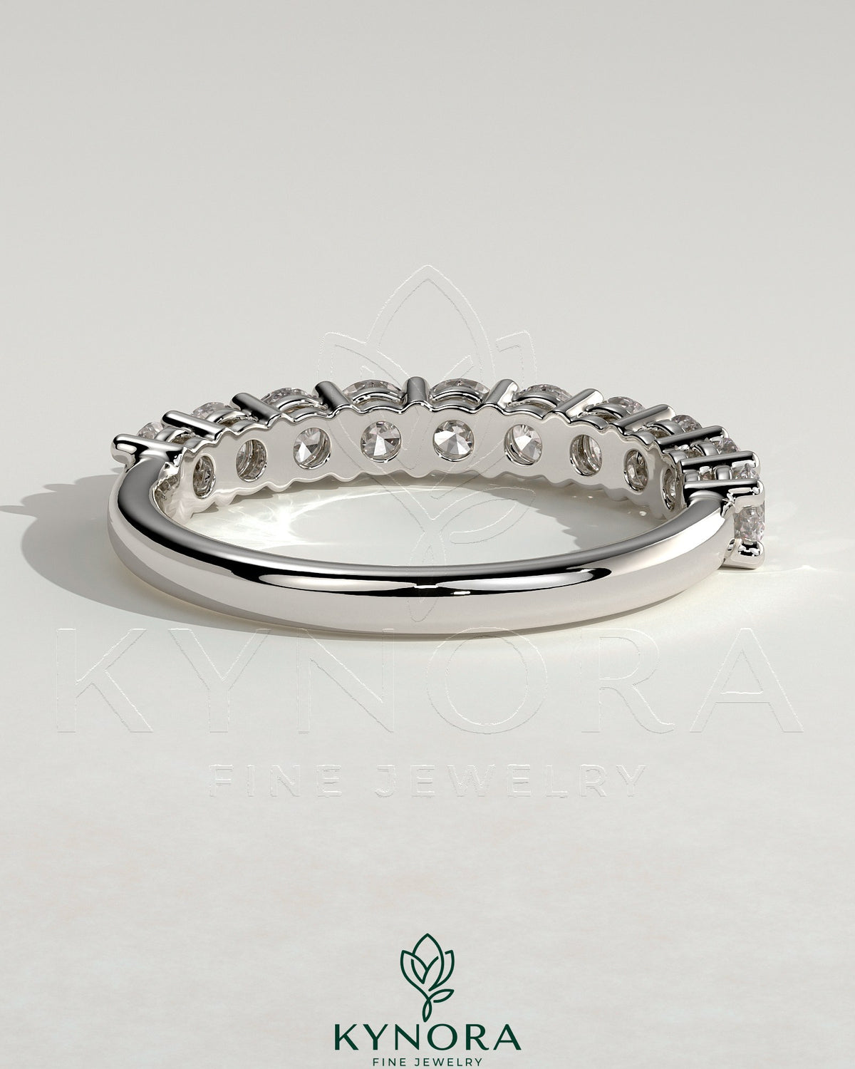 Kynora CJ round eternity wedding band ring with continuous diamond or gemstone design, elegant and timeless jewelry piece.