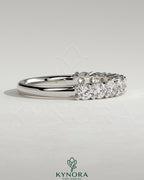 Kynora CJ round eternity wedding band with a continuous row of sparkling gemstones, crafted for elegant bridal jewelry.