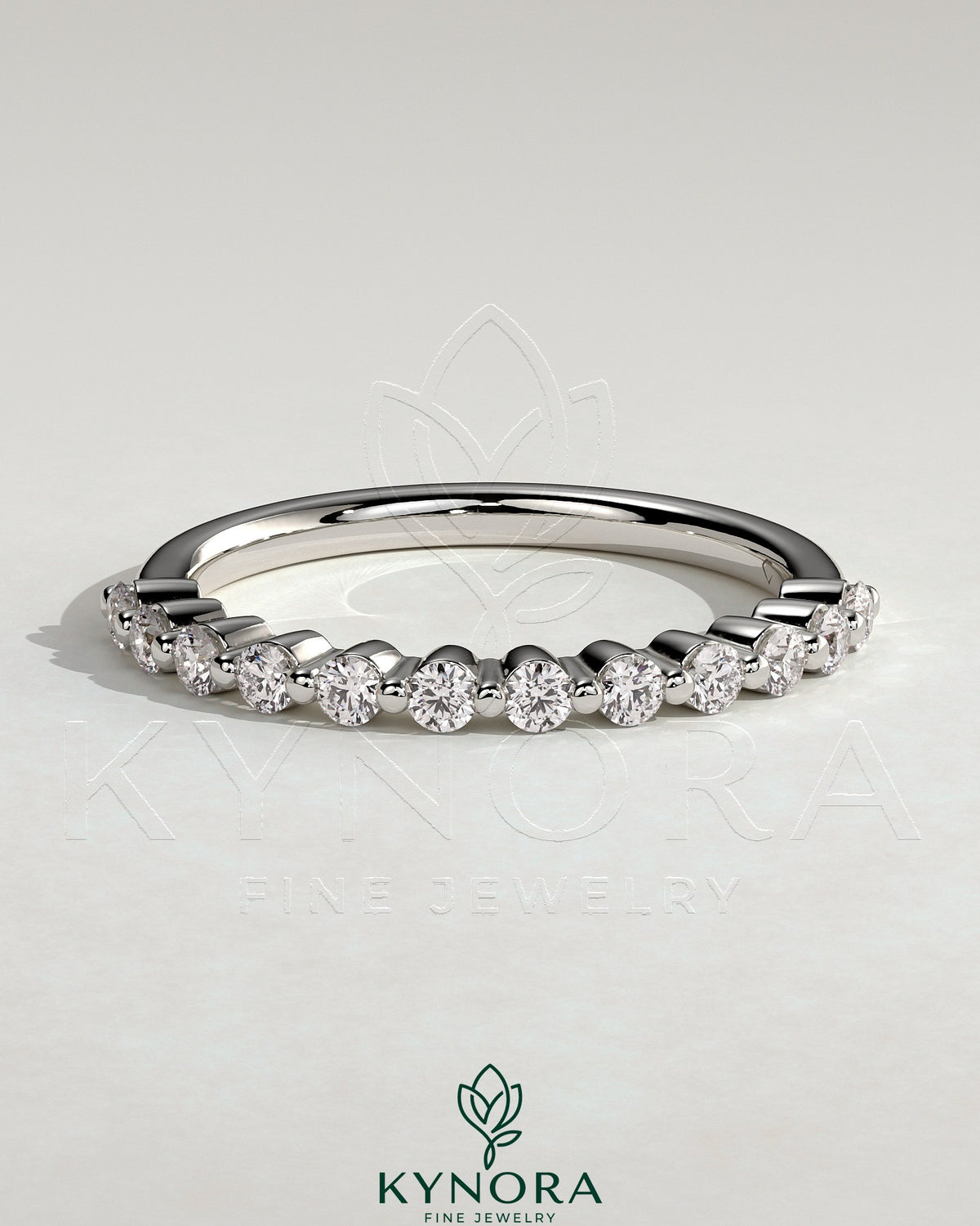 Round shared prong accent stone wedding ring by Kynora CJ, featuring a sleek band with sparkling accent stones.