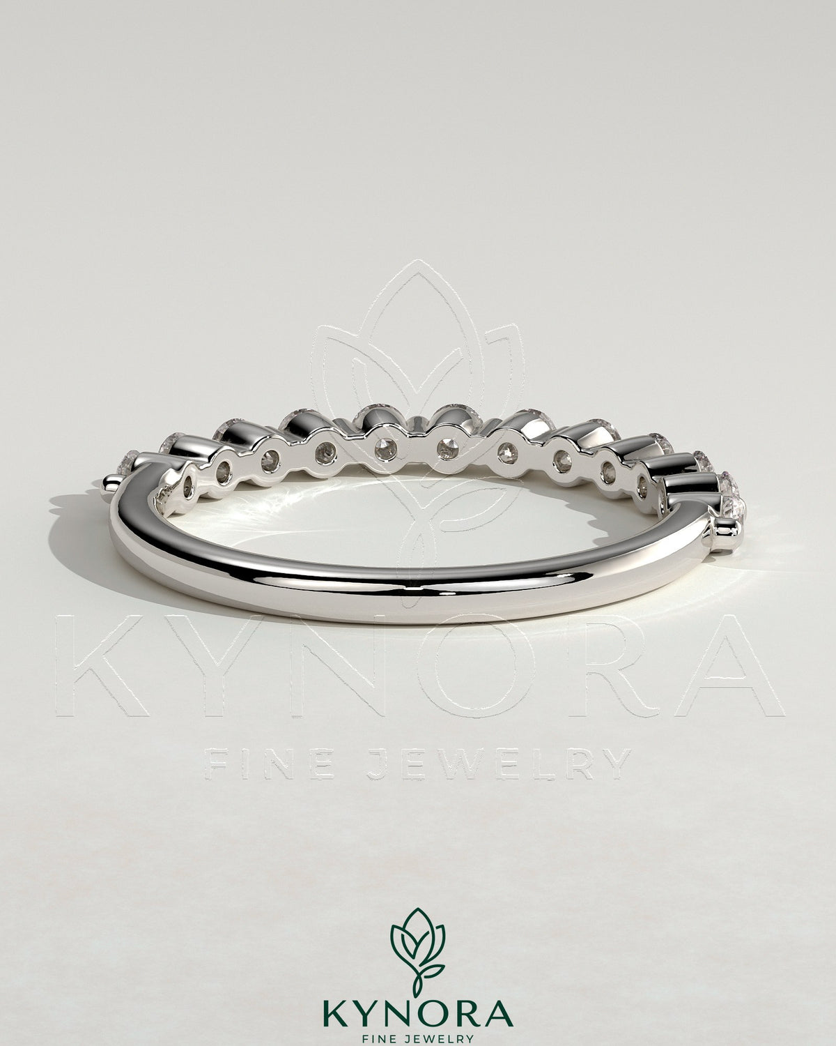 Round shared prong accent stone wedding ring by Kynora CJ, featuring a polished band with sparkling accent stones.