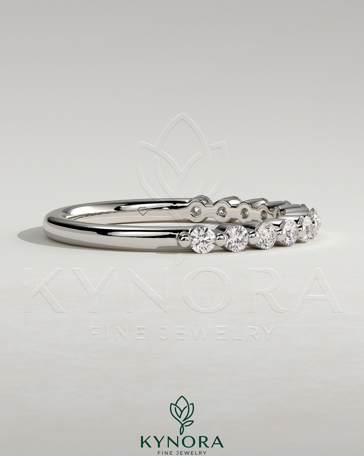 Round shared prong accent stone wedding band by Kynora CJ, featuring sparkling stones and a classic gold finish.