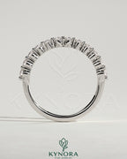 Round shared prong accent stone wedding ring by Kynora CJ featuring sparkling stones and a sleek band design.