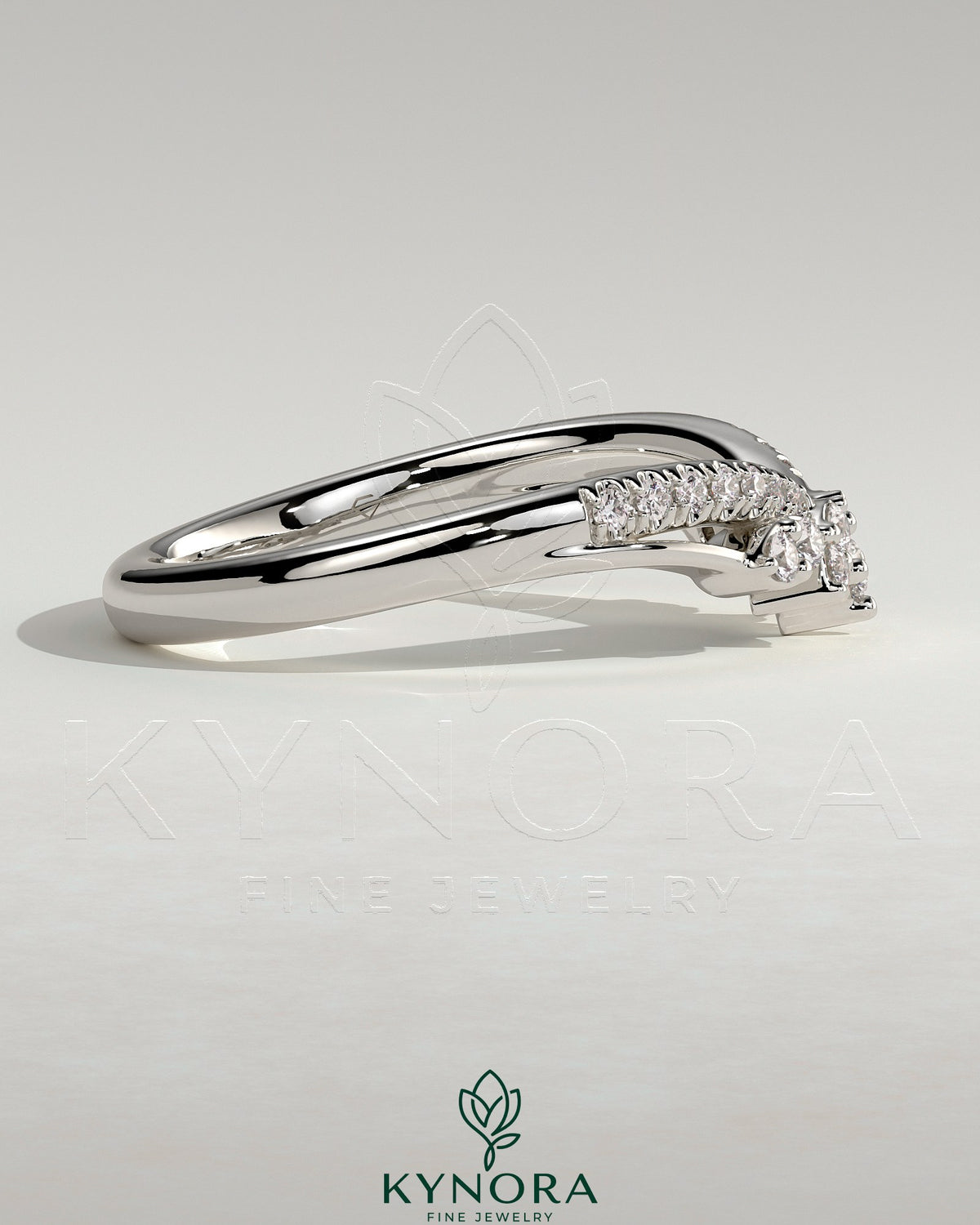Kynora CJ studded tiara-shaped curved wedding band with pave-set stones, elegant jewelry designed for special occasions.