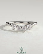 Kynora CJ Trillion Trillion accent stone wedding band with a curved design, featuring sparkling accent stones on a elegant gold band.