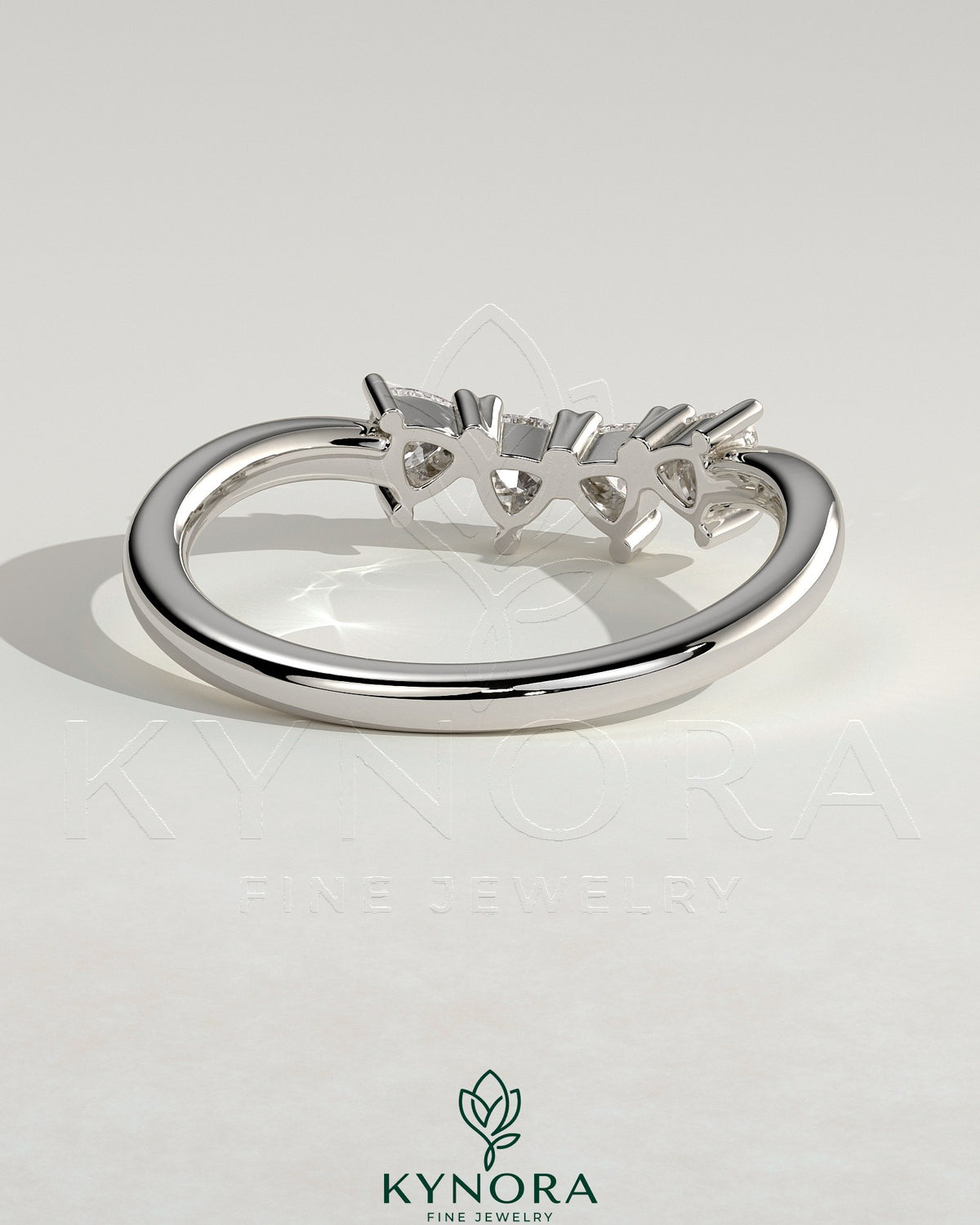 Kynora CJ Trillion Accent Stone wedding band with a curved design, featuring sparkling stones on a sleek gold band.