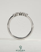 Kynora CJ Trillion Accent Stone wedding band with curved design, featuring sparkling accent stones on a polished metal band.