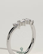 Kynora CJ Trillion Trillion accent stone wedding band with a curved design, showcasing sparkling gemstones on a sleek gold band.