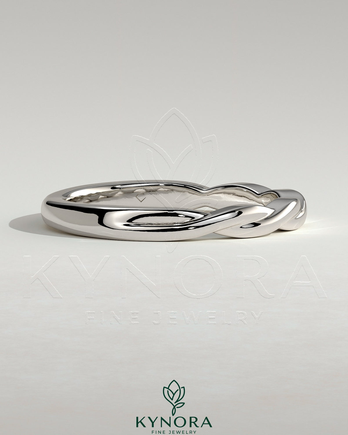 Kynora CJ twisted band wedding ring in polished metal with a braided design, showcasing elegant craftsmanship.