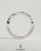 Twisted band wedding ring by Kynora CJ featuring a sleek, intertwined design in polished metal, ideal for wedding jewelry.