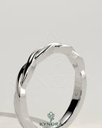 Twisted band wedding ring by Kynora CJ featuring a sleek, elegant design in polished metal for special occasions.