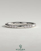 Two third spaced clustered pave band wedding ring by Kynora CJ with intricate diamond detailing on polished gold band.