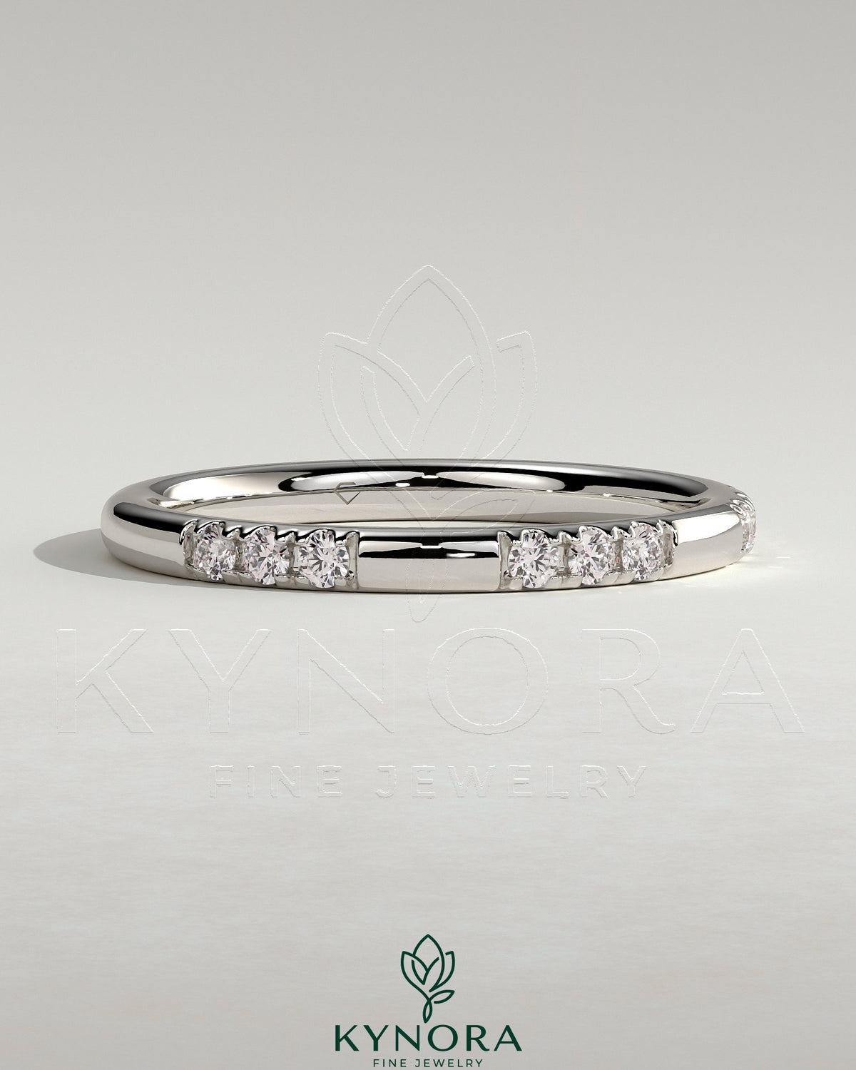 Two third spaced clustered pave band wedding ring by Kynora CJ with intricate diamond detailing on polished gold band.