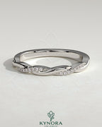 Kynora CJ twisted band wedding ring with pave detailing, elegant two-third design, showcasing intricate craftsmanship and sparkling accents.