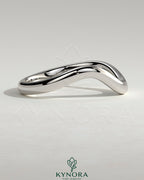 Kynora CJ Wave Band wedding ring with sleek, polished silver finish, simple and elegant design for special occasions.